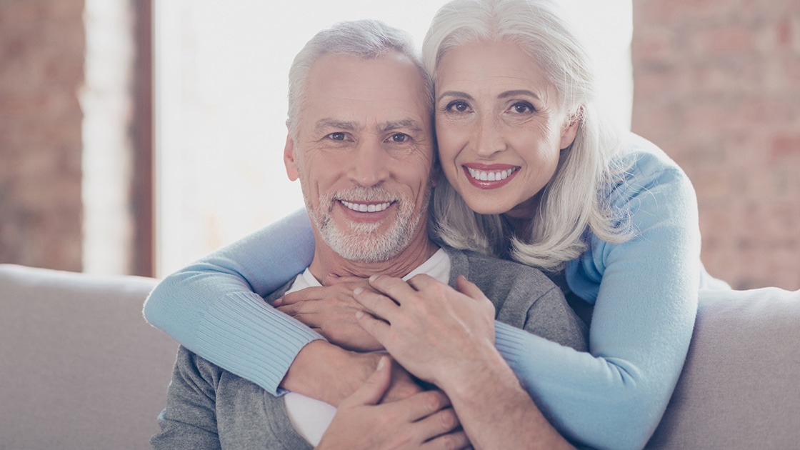 couple smiling after new dentures