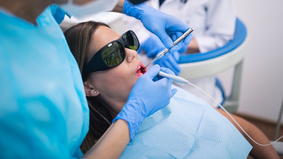 Lady in exam chaor having laser treatment